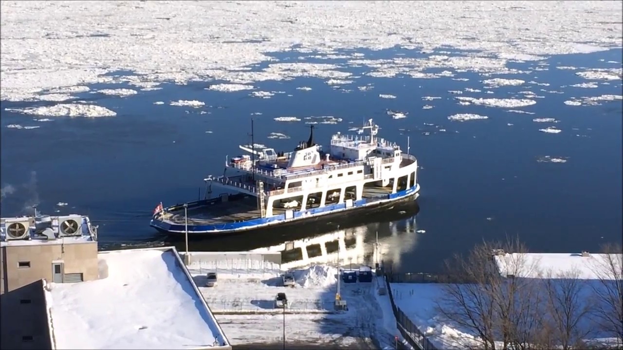 Ferry crossing the frozen St-Lawrence River between Quebec City and Levi