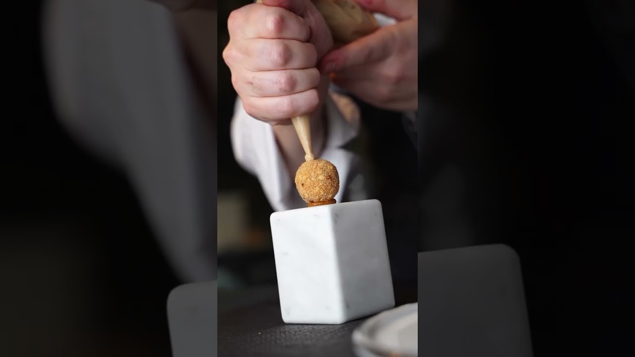Piccione grigliato sulla brace della griglia yakitori AG Grill L Rizzoli in sala davanti ai clienti.