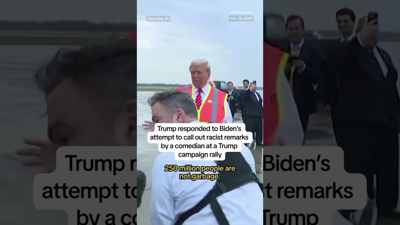 Donald Trump boards a campaign garbage truck in Wisconsin