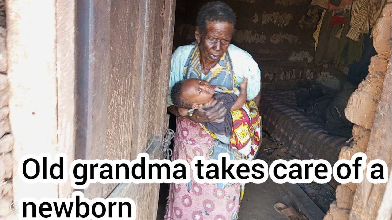 Old great grandmother takes care of a newborn child// African village