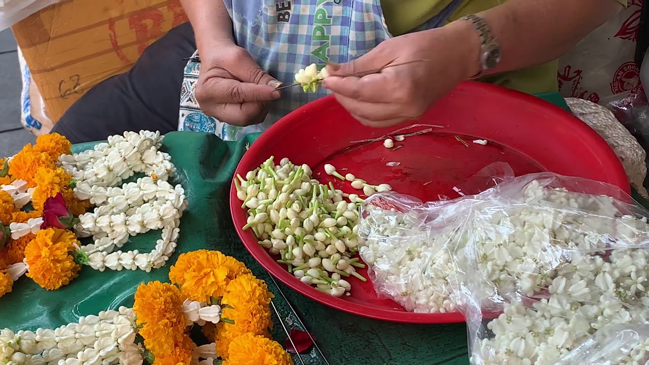 The making of flower lei for temple offerings in Bangkok