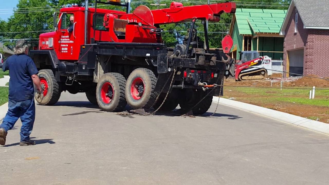 Tow truck pulling a dump truck