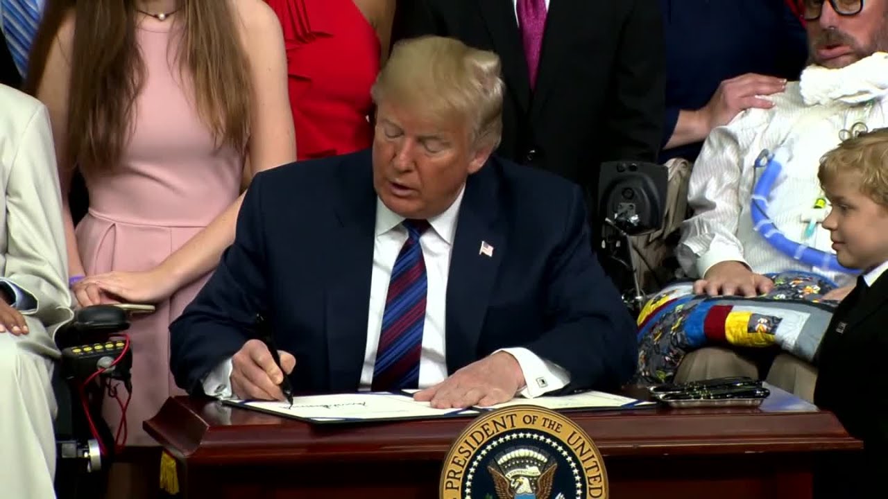 President Trump Hugs Boy After Bill Signing