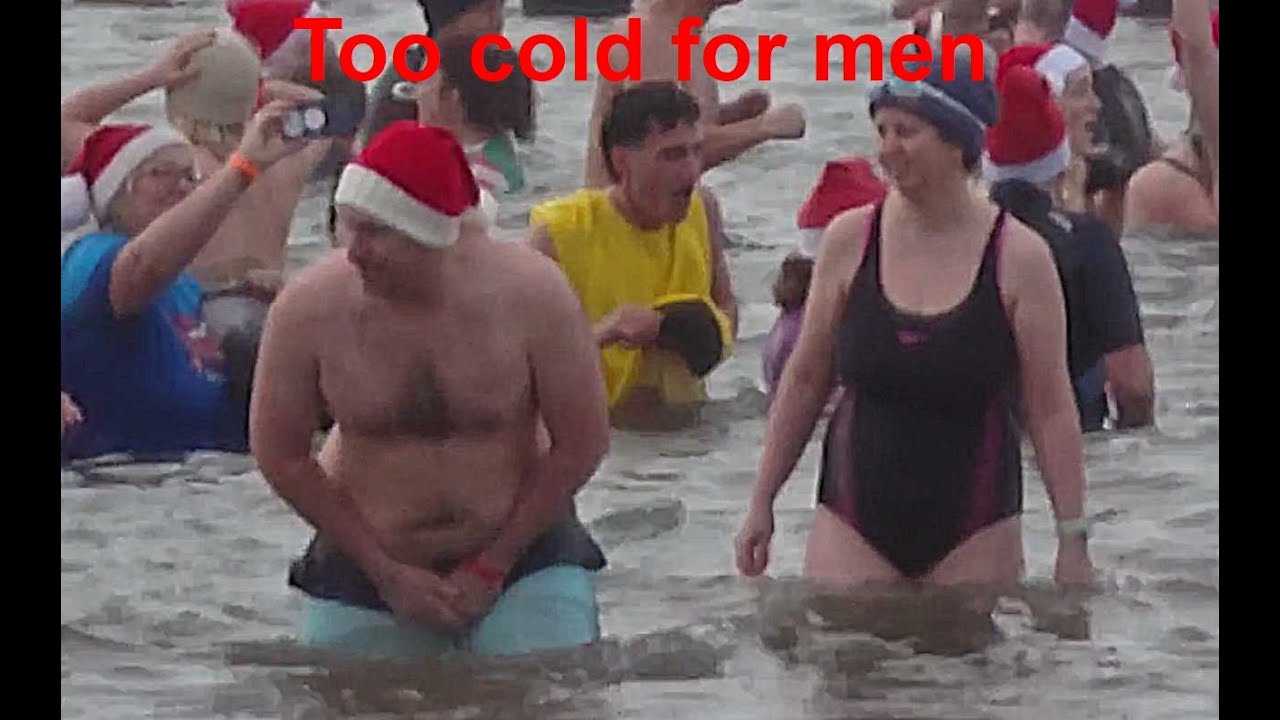 Men suffer on Teignmouth Boxing day run in to the sea.