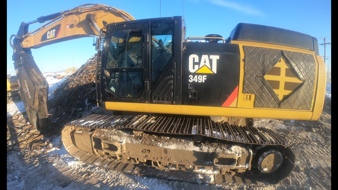 Giant spool being destroyed at scrapyard in Alaska by Demolition shear excavator