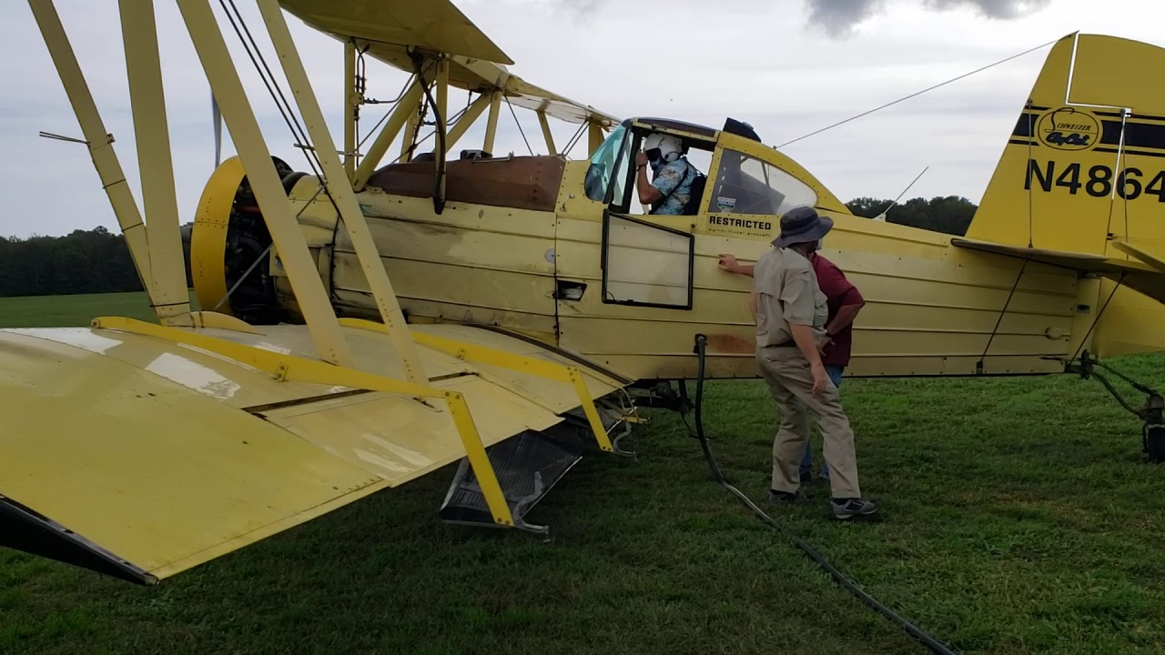 radial engine ag cat geting loaded with seed