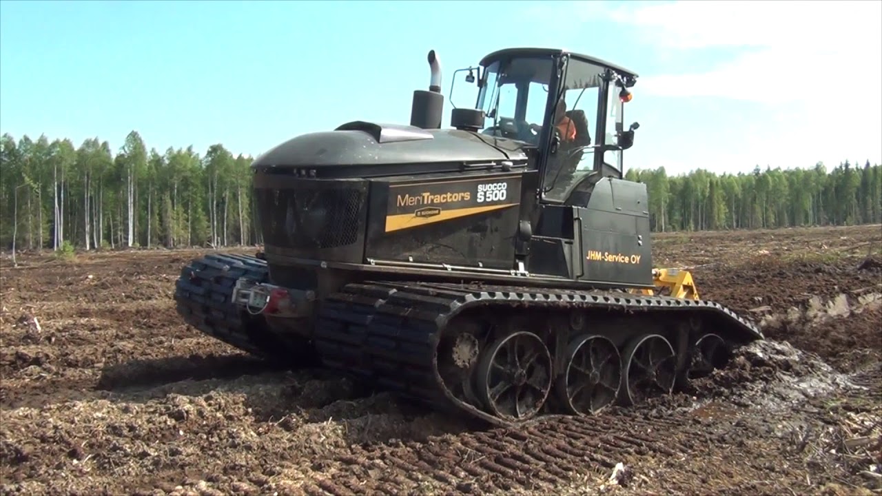 Tracked carrier Suocco S500 clearing new peat land with Meripeat ditcher in summer conditions