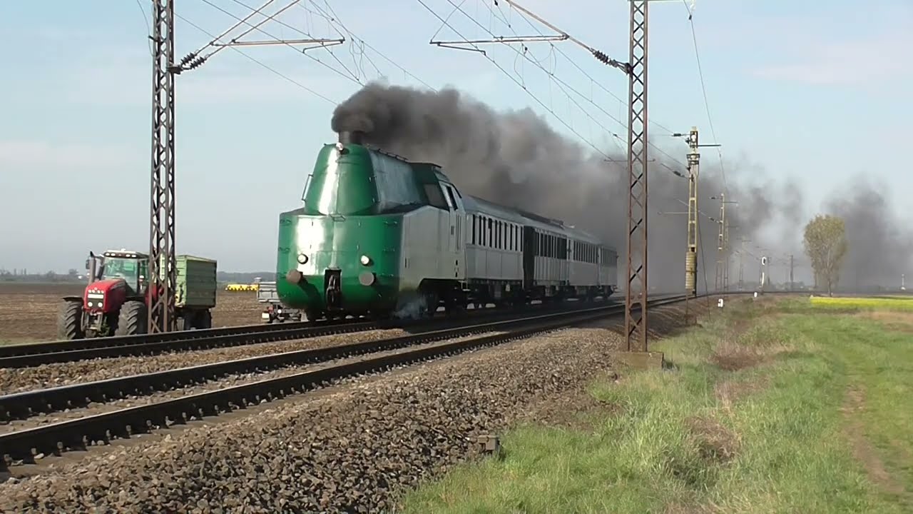 Streamlined tank engine M&Aacute;V 242,001 with a chartered train
