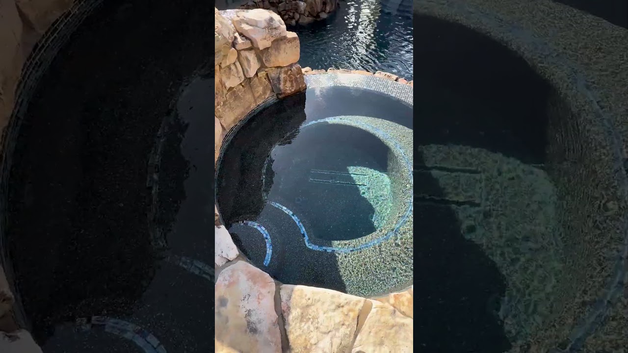 This pool has it all: featuring a massive grotto, elevated hot tub, upper and lower pools
