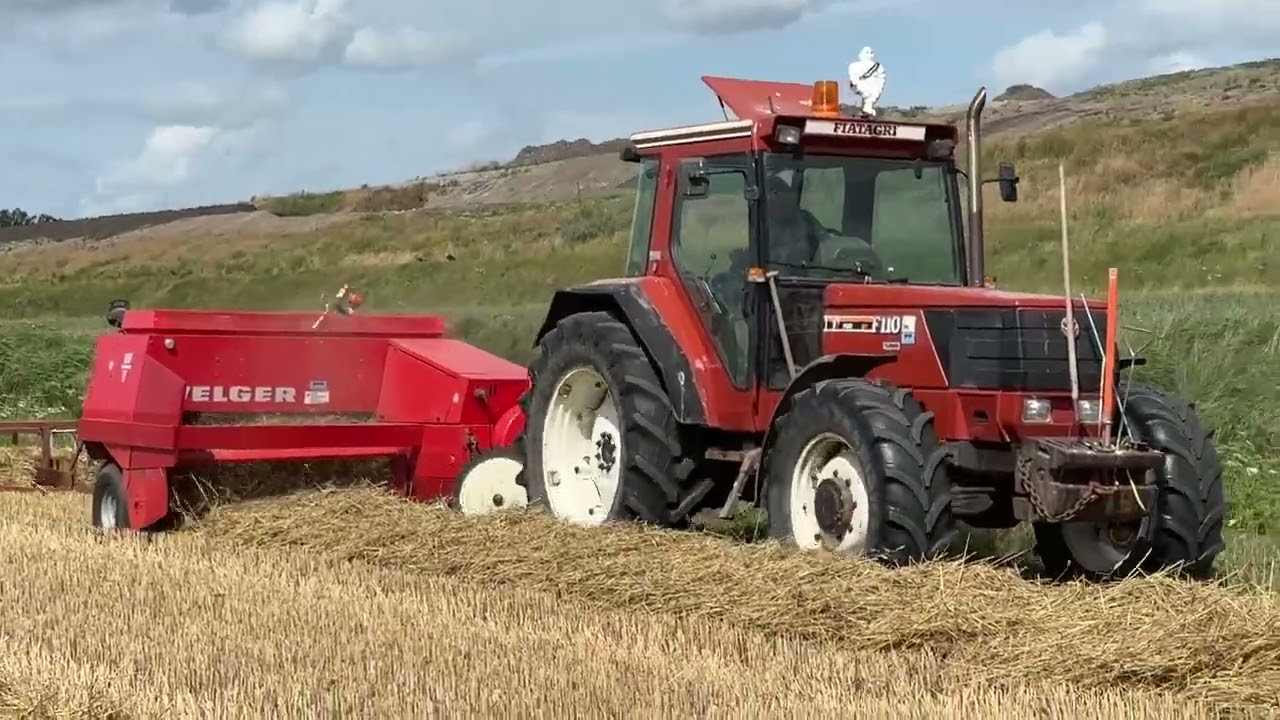 Fiat Agri F110 baling straw with Welger and a bale collector
