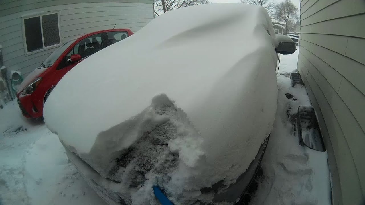 Brushing Snow Off Car After 3-day Snowstorm