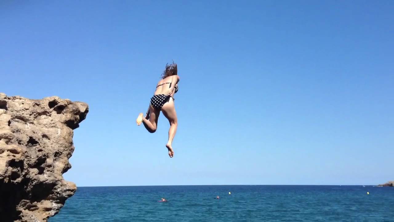 Cliff jumping at Platja Raco Illa Roja, Spain