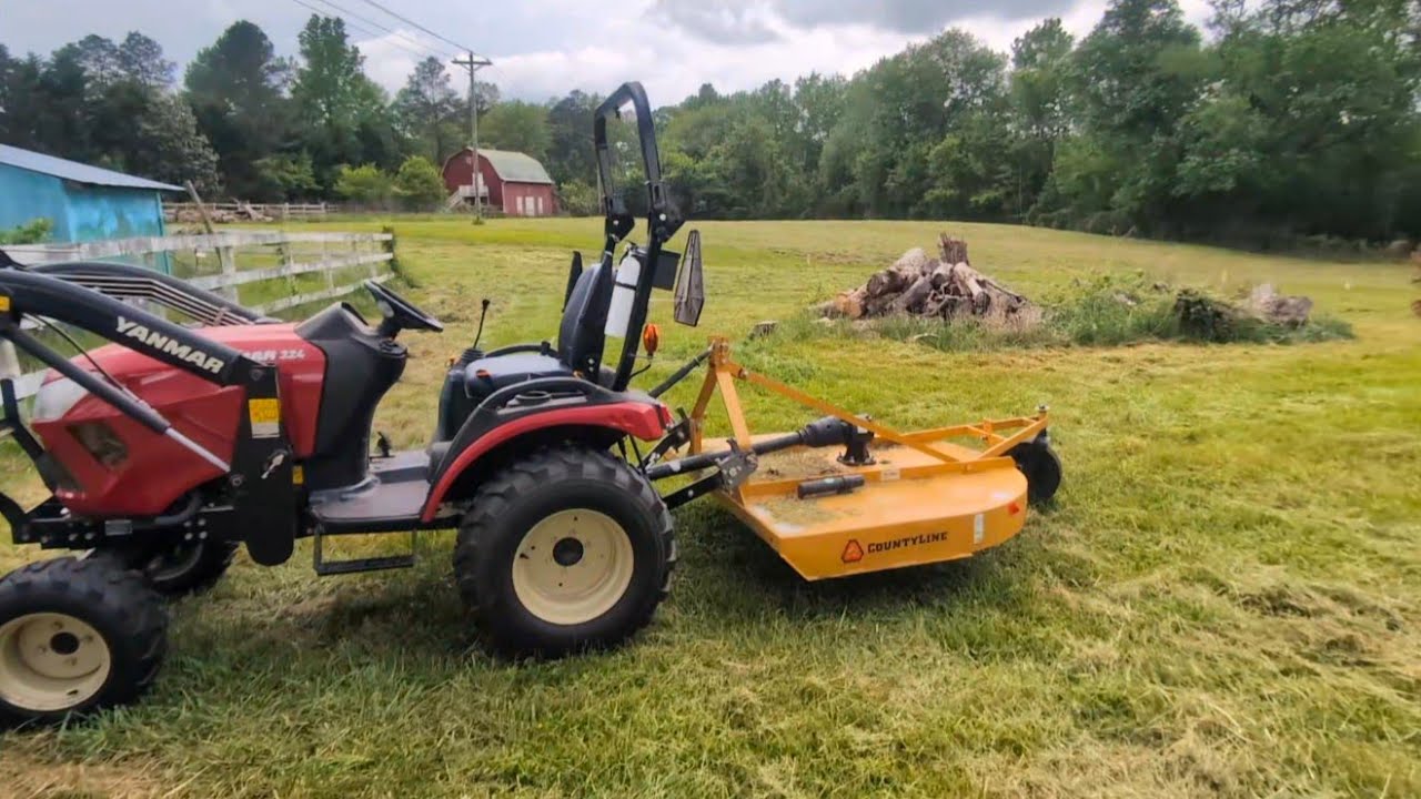 Yanmar SA324 compact tractor, 5' Tractor Supply rotary cutter, Ray-Ban Meta smart glasses.
