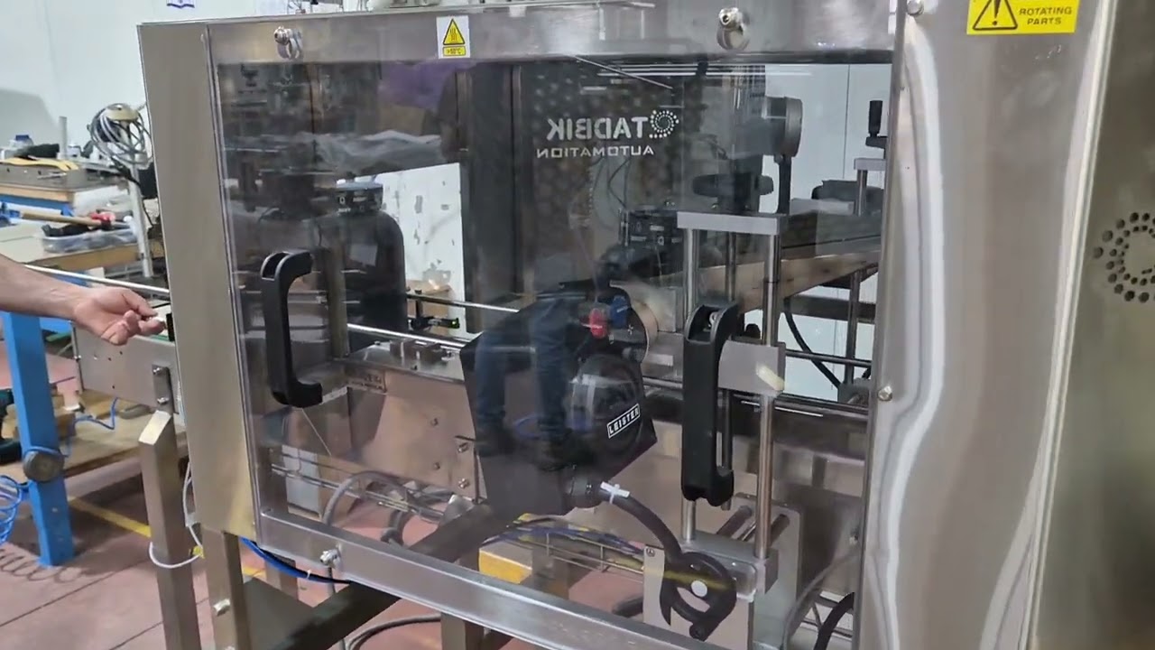 Wrap-Around Labeling Machine for Cylindrical Containers withTamper-Evident Shrink Module by TADBIK