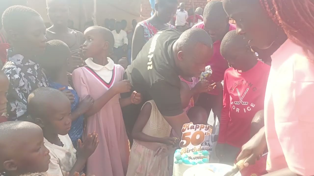 MOMENT OF CUTTING THE CAKE WITH PASTOR ALBAN BYAMUKAMA @ 50YEARS AND KITIGUMA CHILDREN