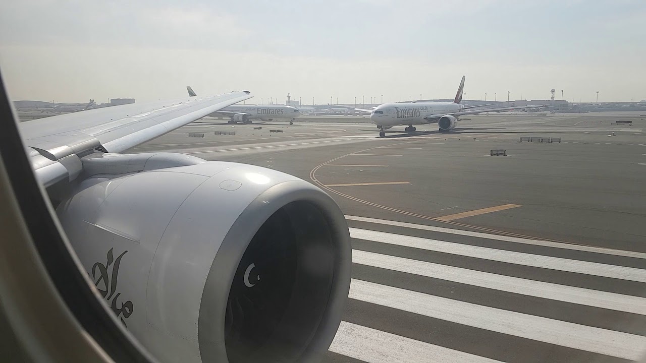 Emirates Boeing 777-300ER takeoff Dubai on hazy boxing day