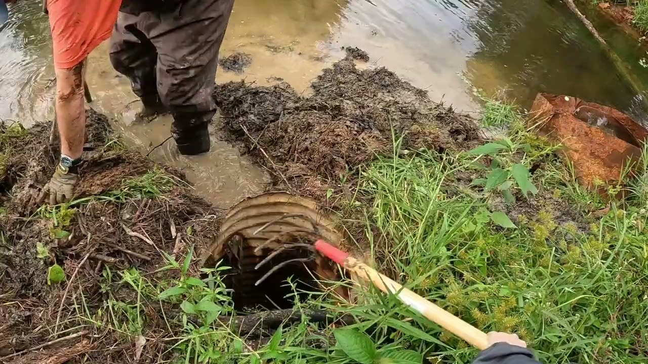 Uncovering small lake exit drain .