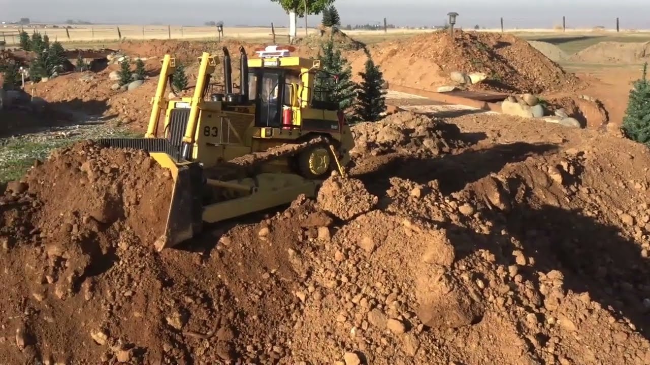 2 DRX dozers pushing, cutting road grade. 374F diggin hard.