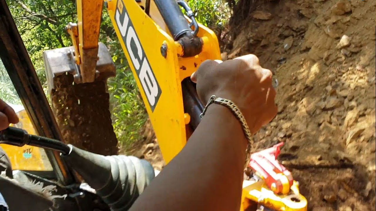 Inside Cabin - JCB Backhoe as Excavator Felling Tree-Cutting Hill