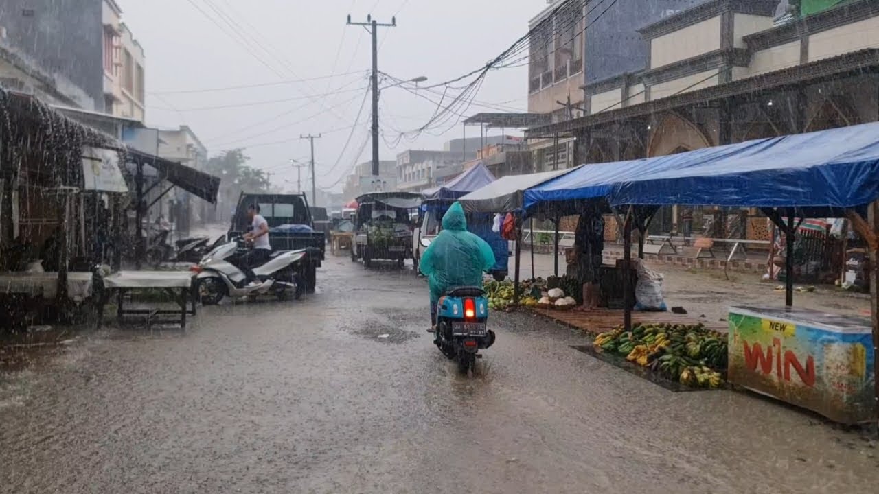Heavy rain and overflowing water on the streets oftraditional markets in rural Indonesia