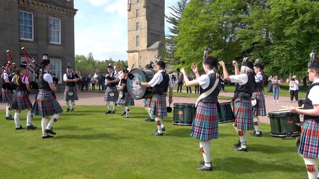 Strathisla Pipe Band march in playing Wi' a Hundred Pipers during 2022 Gordon Castle Highland Games