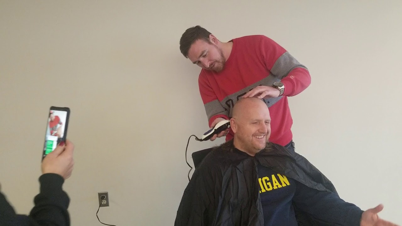 Wolverine Steve pays off his bet to Buckeye Drew at office