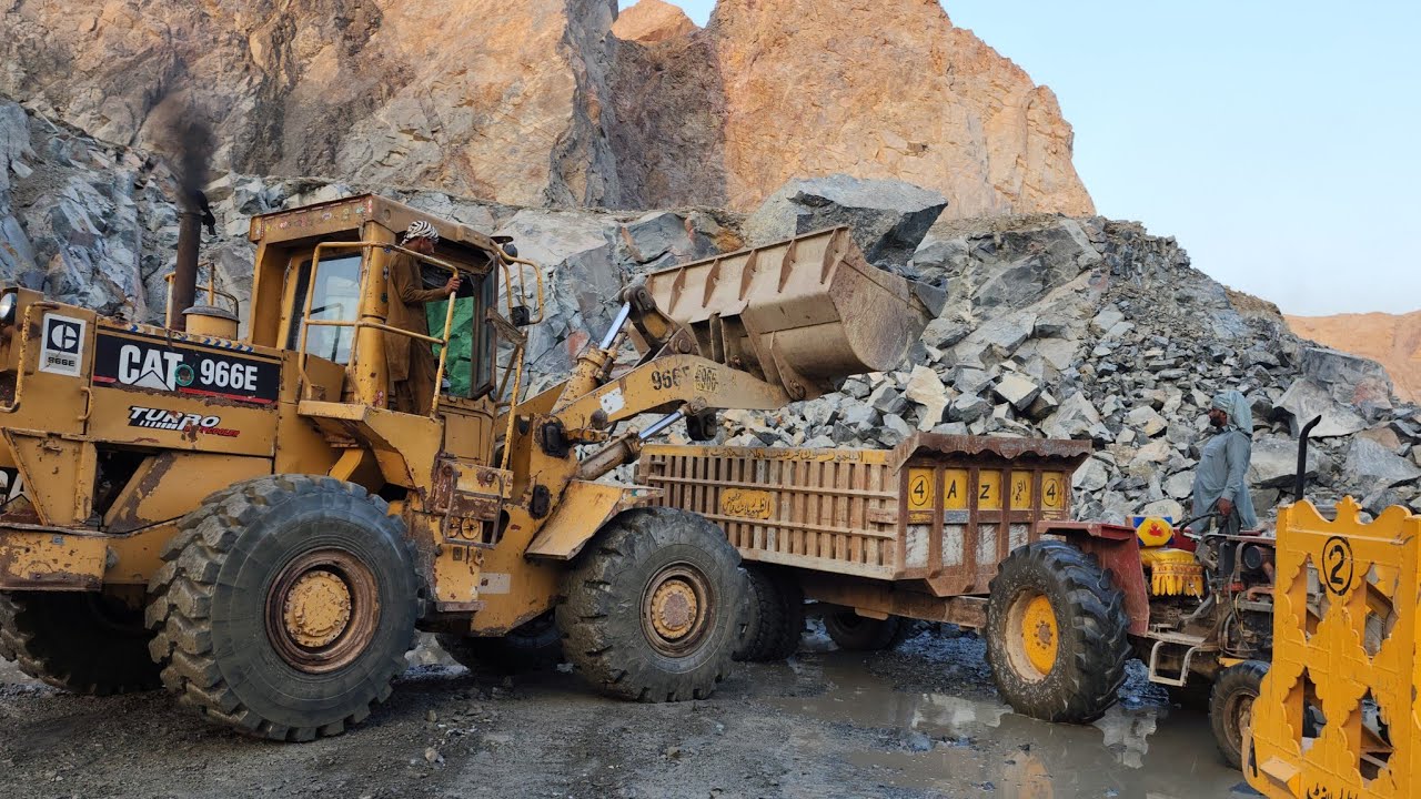 How Big Rocks are Loaded into Dump Trucks & Trolleys: Caterpillar 966E at Quarry Loading