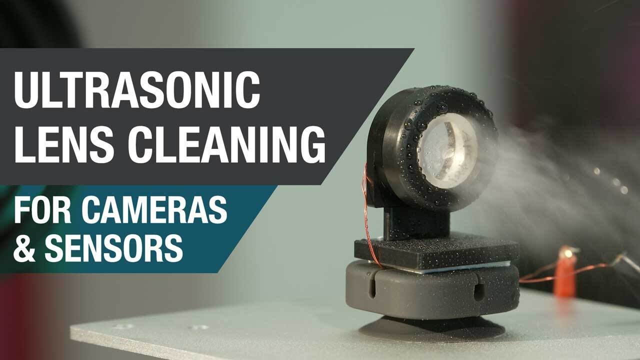 Ultrasonic lens cleaning for self-cleaning cameras