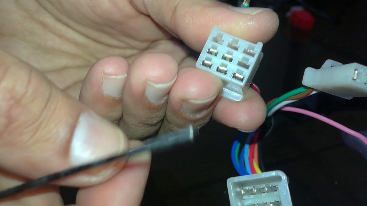 Removing pins from a male connector of automotive wiring harness