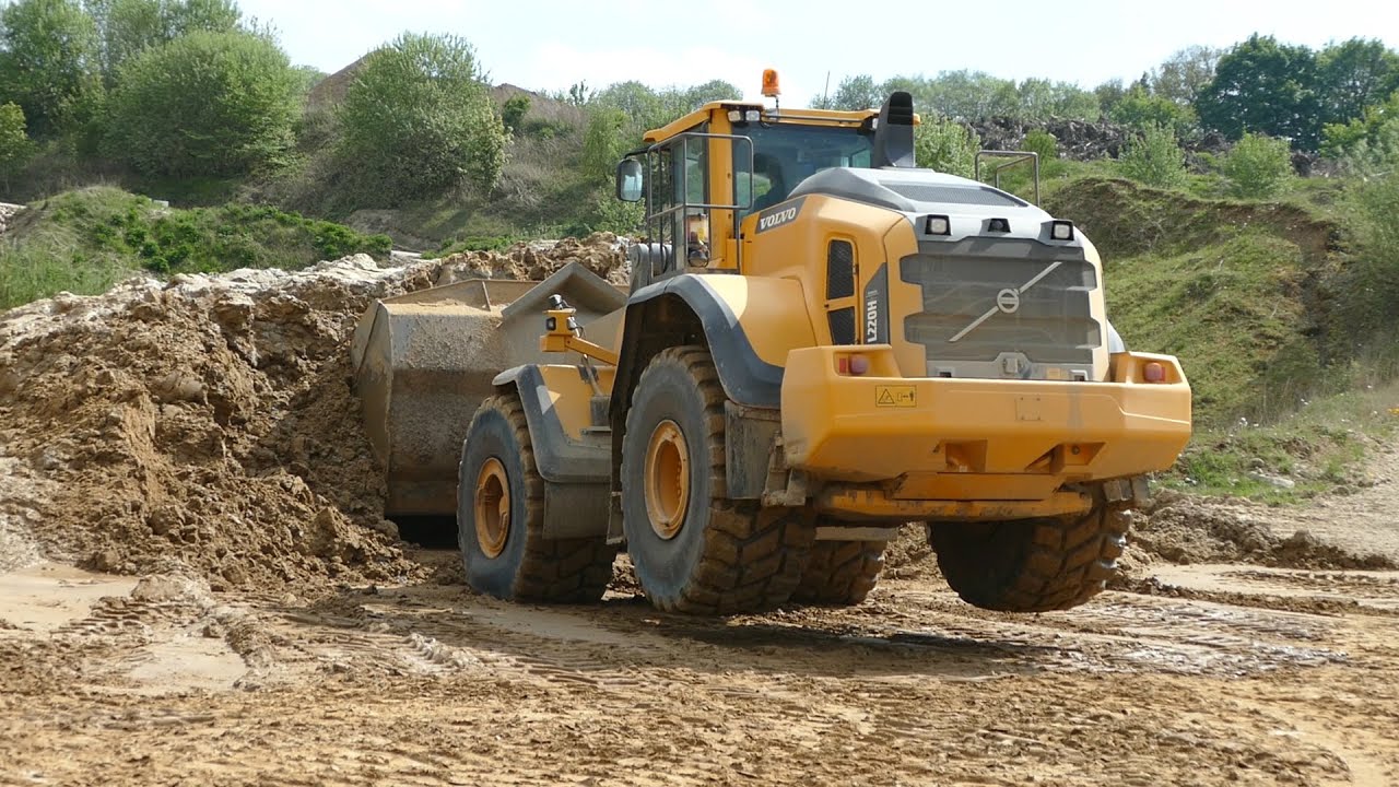 Volvo L220H Wheel-Loader goes sky high while moving overburden in gravel pit | DK Construction