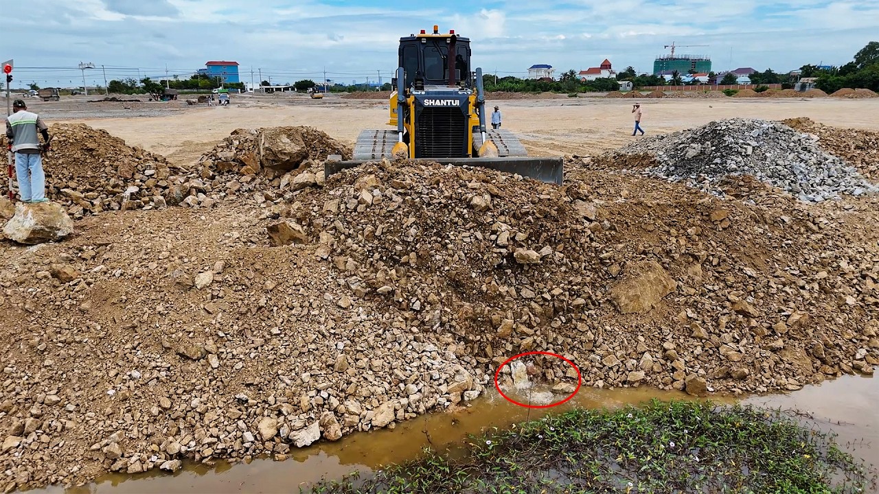 Great skill bulldozer pushing soil to filling up land 