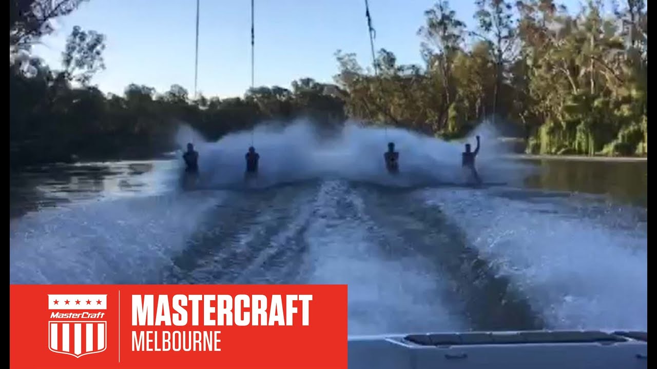 4 PEOPLE BARE FOOTING BEHIND A MASTERCRAFT PROSTAR