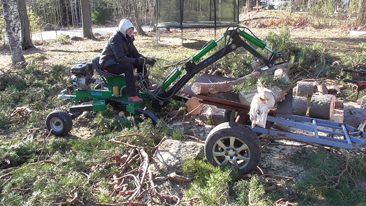 Log splitter attachment to mini backhoe in action