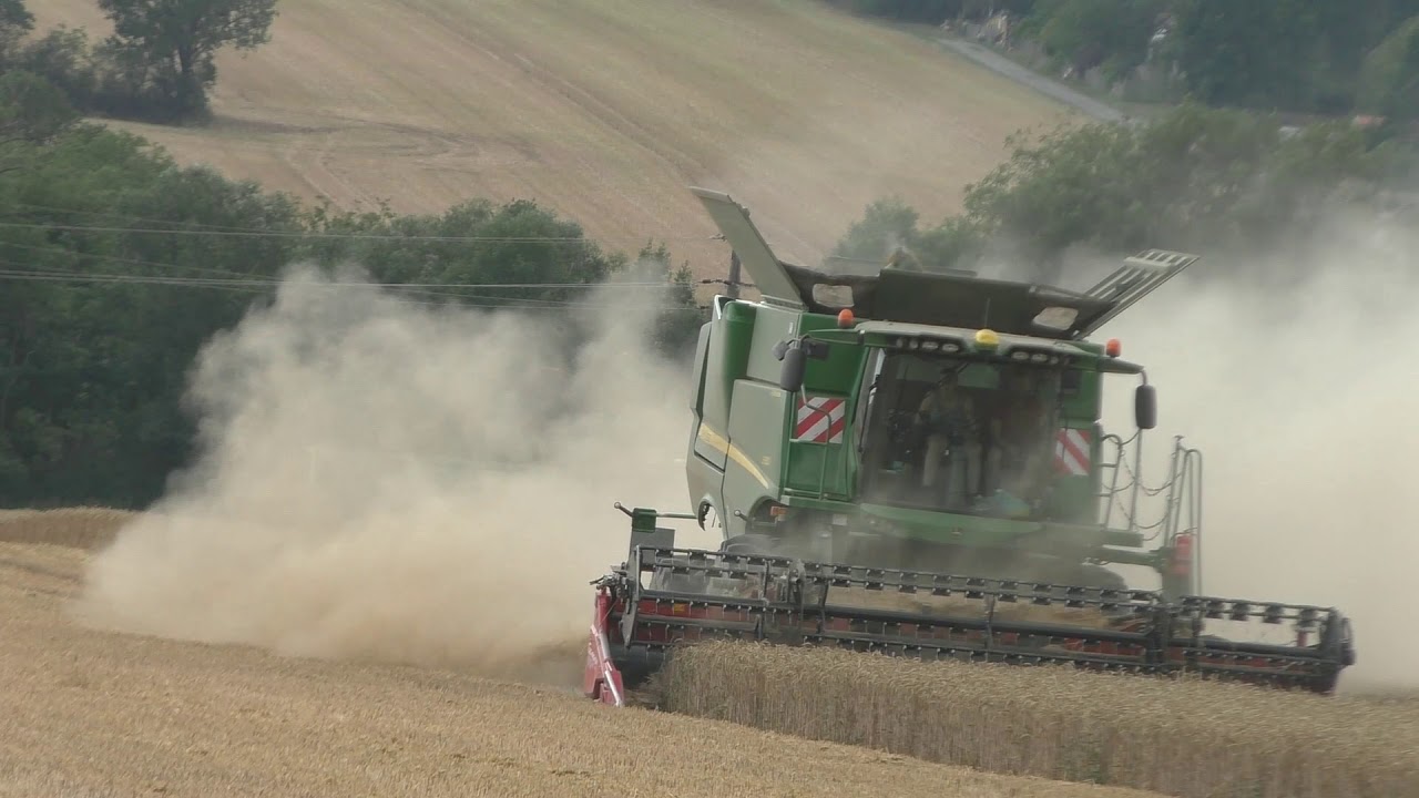 Ein grüner Hirsch beim Arbeiten Weizen Dreschen mit John Deere S680 mit Klappbaren Geringhof 660 Sch