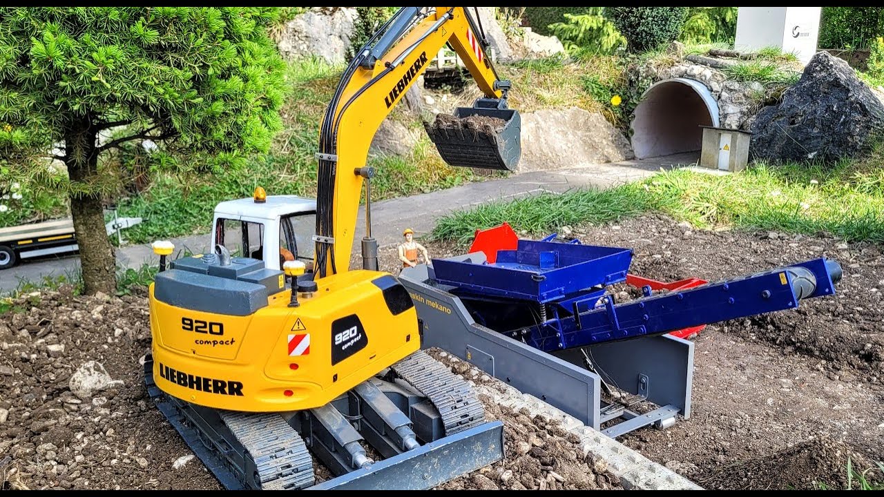Screening and crushing rock RC excavator Liebherr R920, Scania 10x8 Truck, Cat 963D loader.