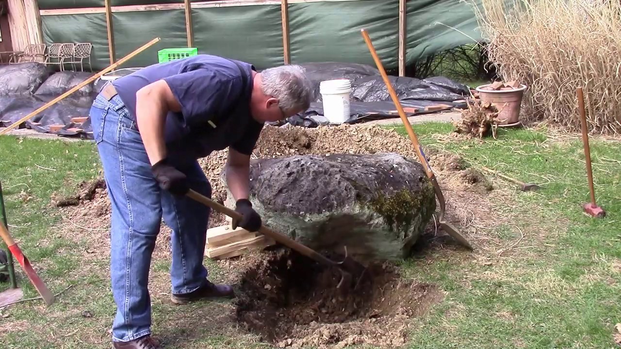 Moving a big rock with a hand truck, a lawn tractor and a willing wife.