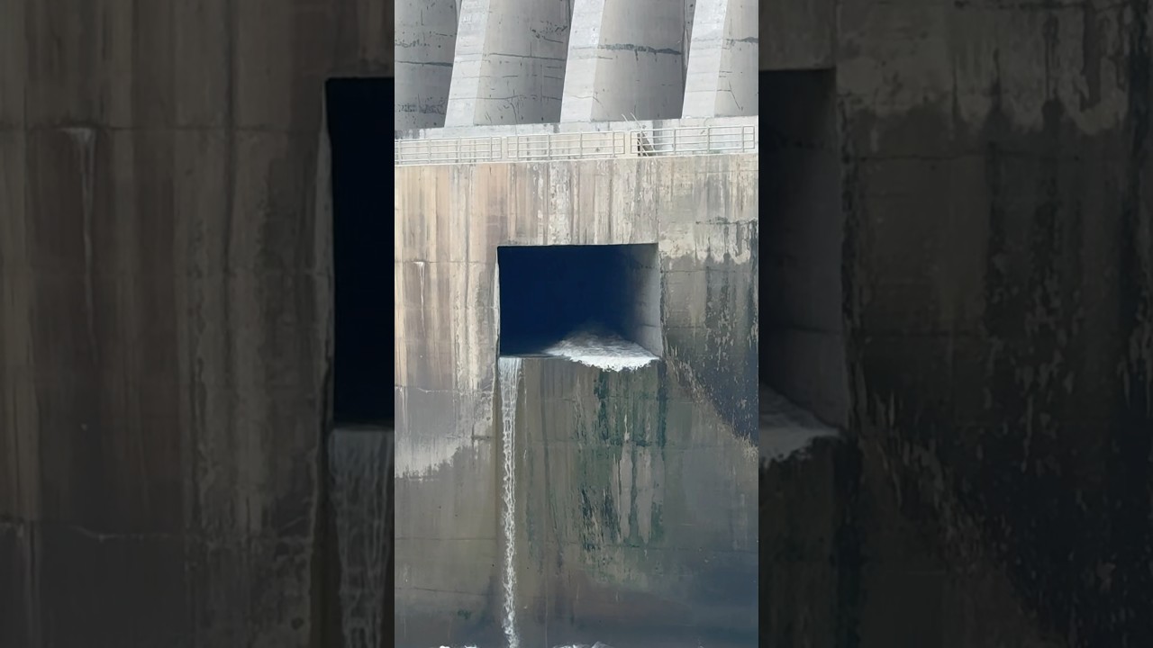 Dam Sluice gate opening with 20cumecs discharge into river downstream