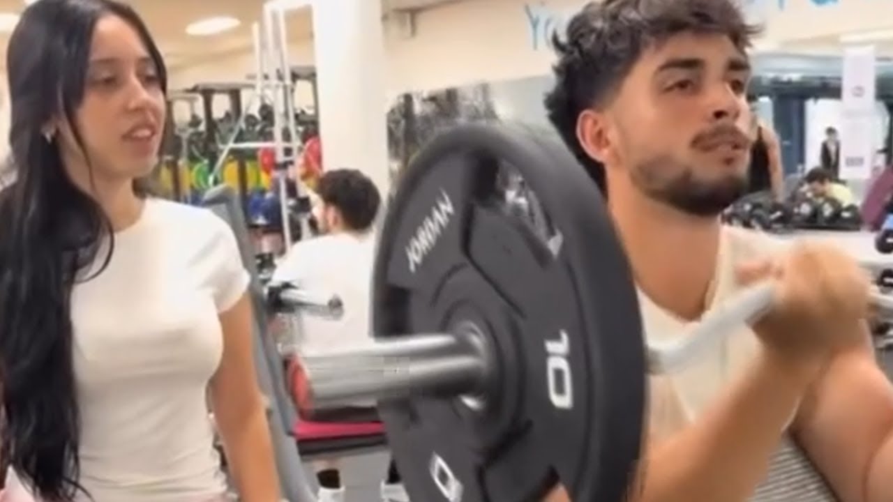 Woman Helps Man At The Gym