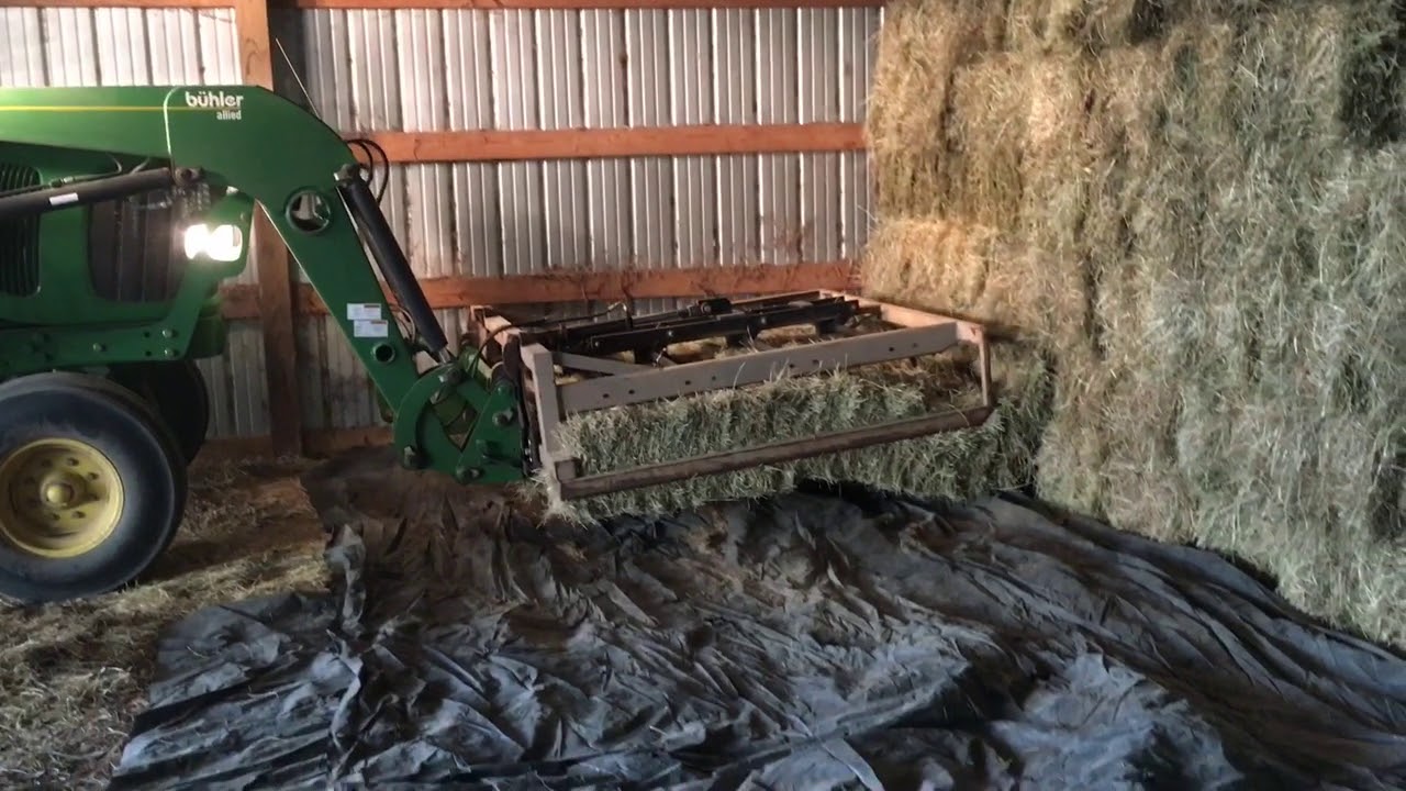 Stacking hay with grapple