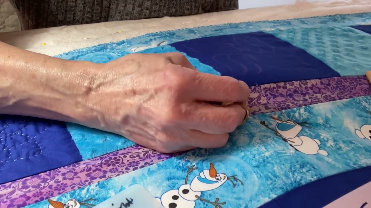 Quilting quietly on the Snowflake designs on the Frozen quilt