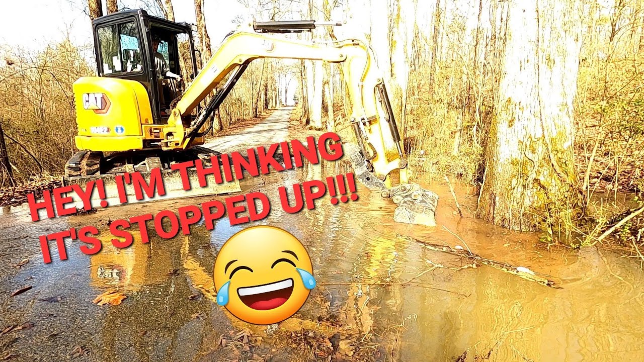 HEY! THE ROAD IS FLOODED!  CAT 304 CLEARING THE PLUG