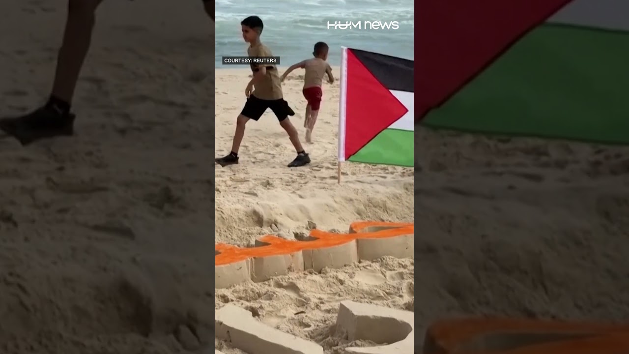 Palestinians create sand art on Gaza beach in support of the Egyptian coach