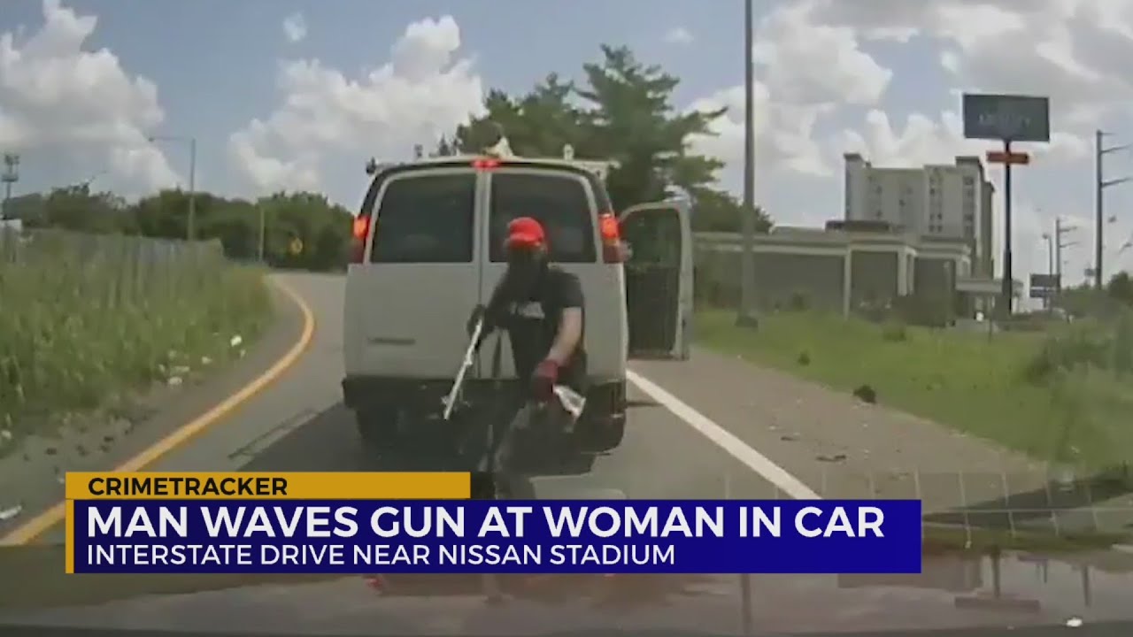 Man waves gun at woman in car