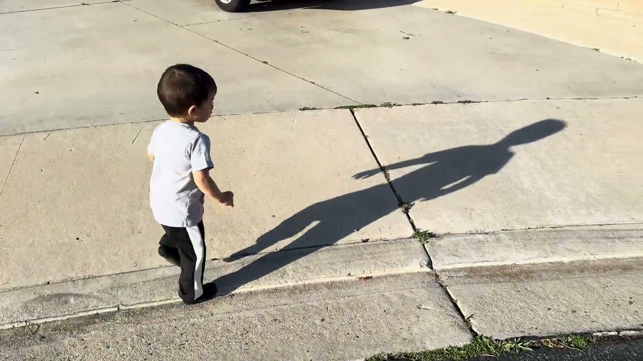 Toddler tries to run from his shadow. Will he succeed?