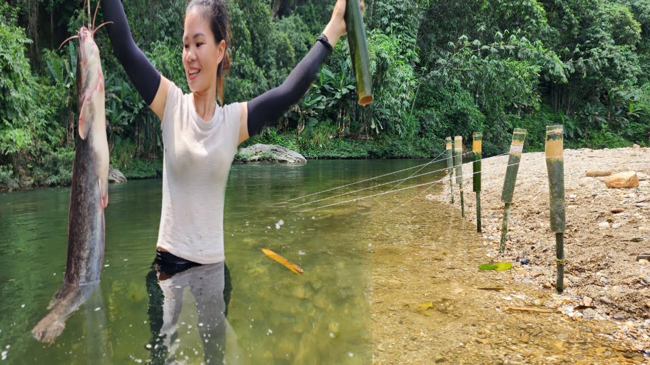 Using bamboo tubes to fish, Ana caught giant carp and catfish in a large stream.