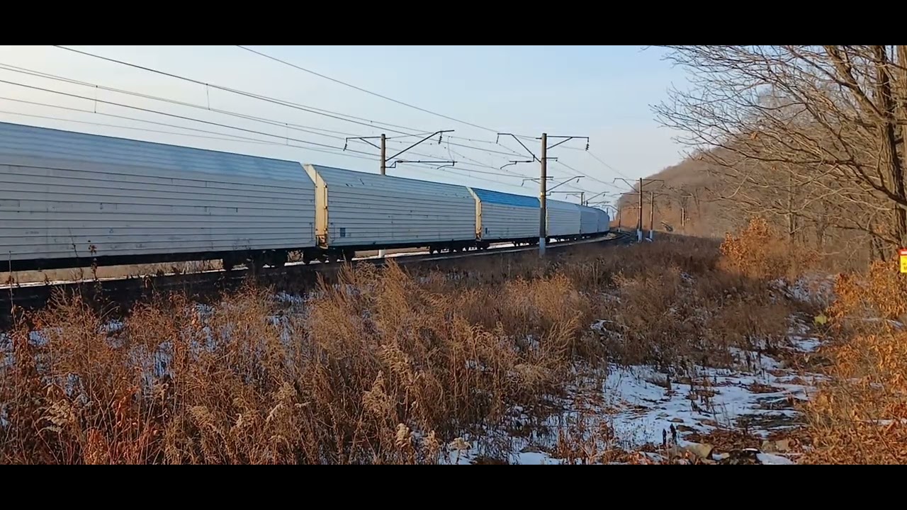 Электровоз 2ЭС5К-052 "Ермак" со смешанным грузовым поездом выходит из кривой,следуя по Транссибу.