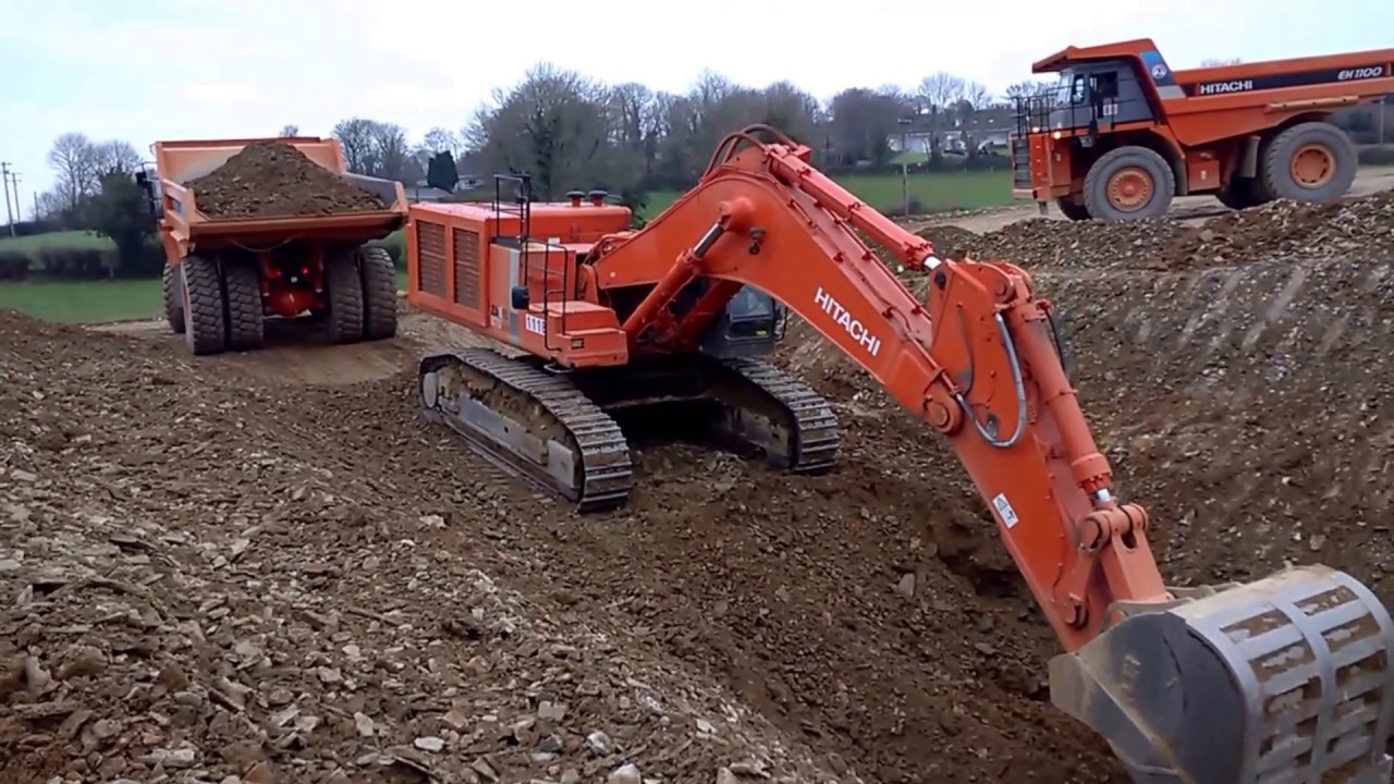 Hitachi excavator digging a trench on a road construction site
