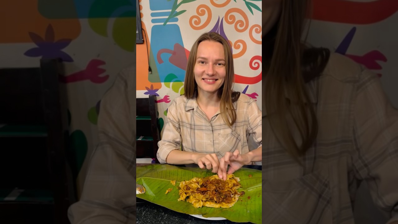 A foreigner  having Kizhi chicken parotta at Kuttanad Kerala food  restaurant Bangalore