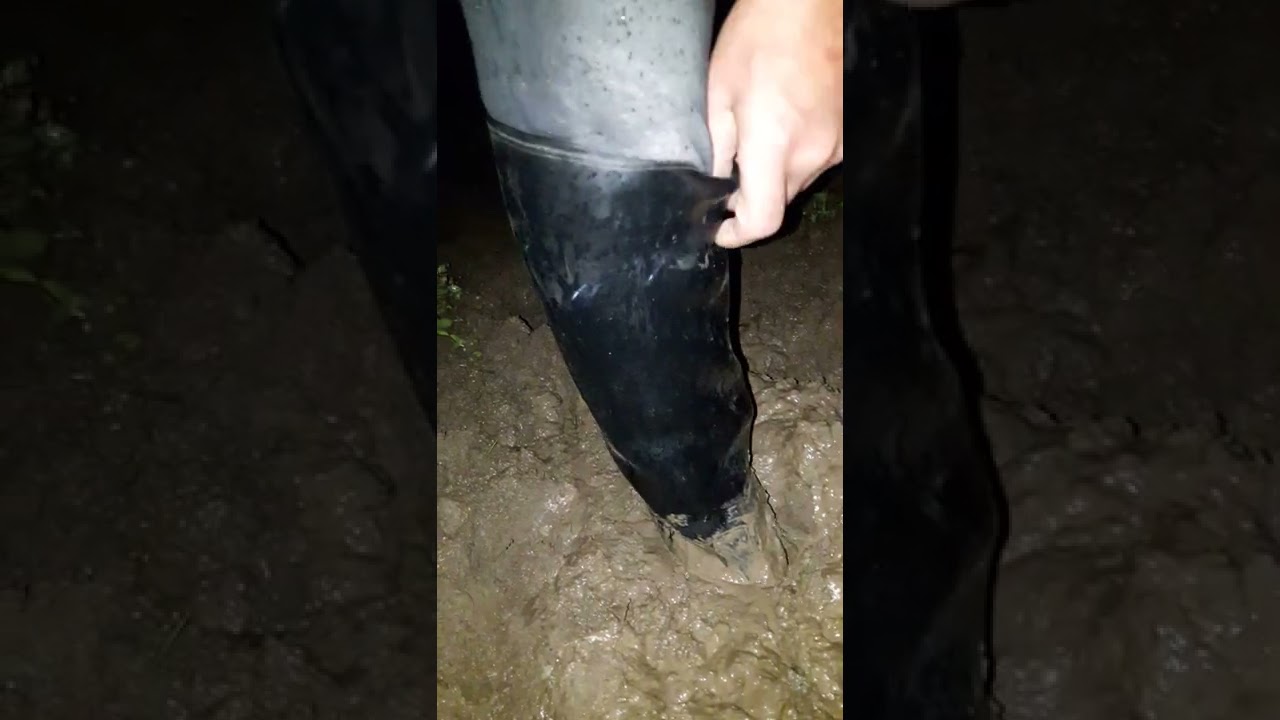 old Aigle start rubber riding boots barefoot and stuck in mud