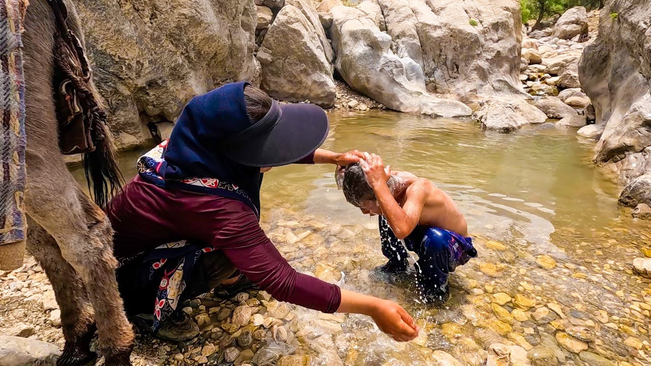 Nomads go to the mountains to provide water and bath for children : Nomads of Iran